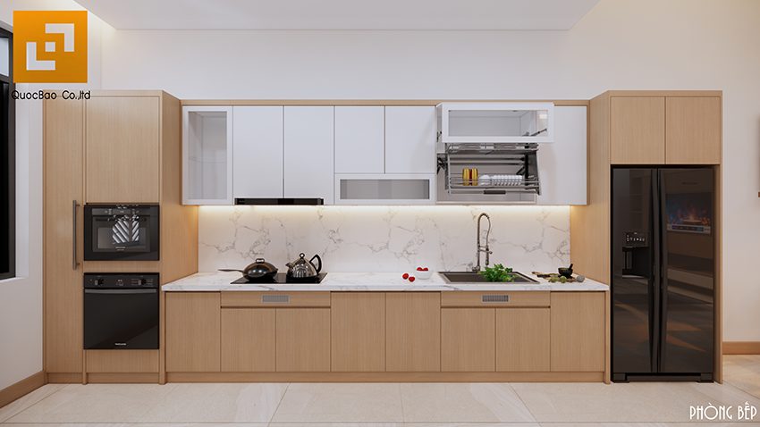 Kệ bếp với thiết kế ốp đá khiến không gian bếp trở nên sáng hơn nhờ độ bắt sáng và phản chiếu từ mặt đá lên đồ vật xung quanh. Tủ bếp được thiết kế dạng tủ âm tường, giúp tối ưu hóa không gian và tạo sự gọn gàng, ngăn nắp.
